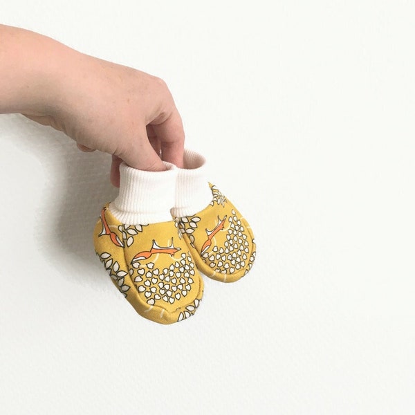 Soft baby booties with foxes. Baby shoes. Slippers. Yellow french terry cotton and white cuffs.