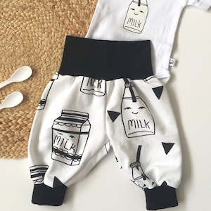 White bubble pants with milk bottles. Cotton. Comfy slouchy infant pants. Harem pants. Black fold over waistband and cuffs. Girl boy image 1