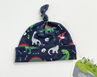 Dark blue knot hat with dinos, baby knotted hat, knot hat, knotted hat, dinosaur print, cotton baby hat, newborn hat. Infant hat with dinos