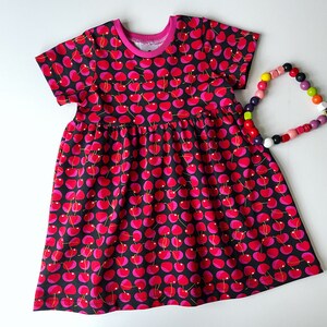 Girl&#39;s dress with cherries. Skater dress. Jersey fabric with short sleeves. Toddler dress, skater dress