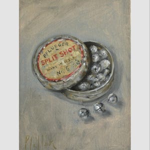 May include: A vintage metal tin of Pflueger Split Shot, Made in U.S.A. No. 6, with several split shot weights visible. The tin is silver with a red and yellow label. Three additional split shot weights are scattered nearby.