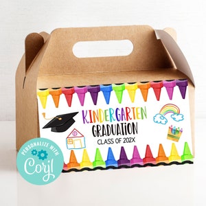 May include: A brown cardboard favor box with a handle. The front of the box has a colorful design of crayons, a graduation cap, a house, a rainbow, and clouds. The text on the box reads "Kindergarten Graduation Class of 202X".