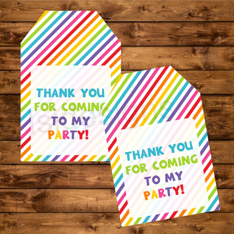 May include: Two colorful thank you tags with a rainbow striped background and white text that says "Thank you for coming to my party!"