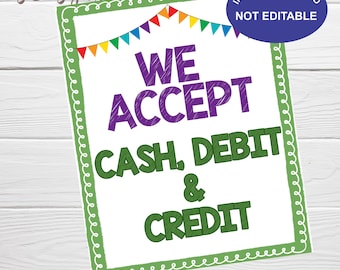 May include: A green and white sign with a festive banner of colorful flags at the top. The sign reads "WE ACCEPT CASH, DEBIT & CREDIT" in a purple and green font. The sign is 8x10 inches.