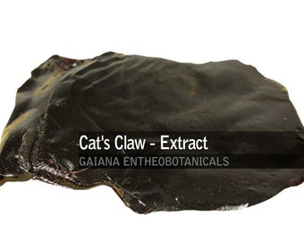 May include: A dark brown, irregularly shaped piece of dried cat's claw extract. The text "Cat's Claw - Extract" and "GAIANA ENTHEOBOTANICALS" is printed on a black background.