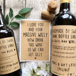 May include: A set of two brown paper wine bottle labels with black text. The text on the first label reads "I love you and your massive willy now drink this wine so we can get silly". The text on the second label reads "Handmade by Swans Wine Bottle Label *Just add Wine* Straight body bottles with high shoulders recommended for this size wine label. Replacing instructions enclosed. Personalised beer labels are also available. Make a gift extra special! www.handmadebyswans.com".