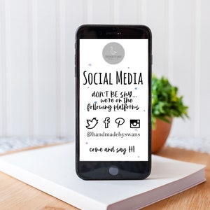 May include: A black smartphone displays a social media graphic with the text "SOCIAL MEDIA" and "don't be shy... we're on the following platforms." The graphic includes social media icons for Twitter, Facebook, Pinterest, and Instagram, with the handle @handmadebyswans.