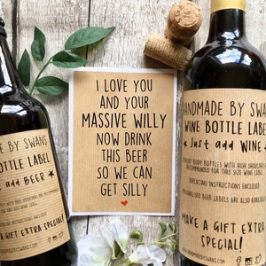 May include: A set of two brown paper gift labels with a humorous message. The labels are for a wine bottle and a beer bottle. The text on the wine label reads "Handmade by Swans Wine Bottle Label *Just add Wine* Straight body bottles with high shoulders recommended for this size wine label. Replacing instructions enclosed. Personalised beer labels are also available. Make a gift extra special! www.handmadebyswans.com". The text on the beer label reads "Be by Swans Bottle Label *add Beer* Bottles with high shoulders are recommended for this size wine label. Replacing instructions enclosed. A gift extra special! www.handmadebyswans.com". The text on the card reads "I love you and your massive willy now drink this beer so we can get silly".