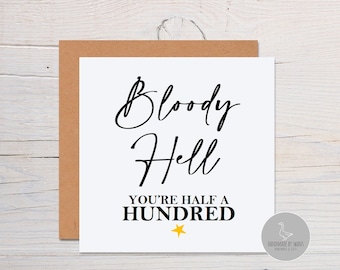 May include: White card with black text that reads "Bloody Hell You're Half A Hundred". A small gold star is below the text. The card is on a brown background.