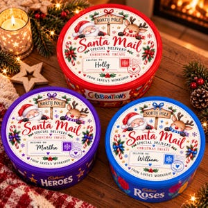 Puede incluir: Tres latas metálicas redondas para dulces navideños en colores rojo, morado y azul. Cada tapa presenta un diseño de North Pole Santa Mail con ilustraciones de Santa Claus y un reno, además de una etiqueta personalizada con los nombres Holly, Martha o William.