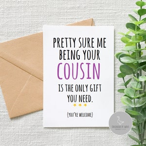 May include: A white card with the text "Pretty sure me being your cousin is the only gift you need. (You're welcome)" in black and purple text. There are three gold stars below the text. The card is sitting on a brown envelope and a green plant.