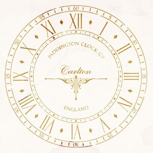 May include: A gold clock face with Roman numerals and a white background. The clock face reads "Paddington Clock Co. Carlton England".
