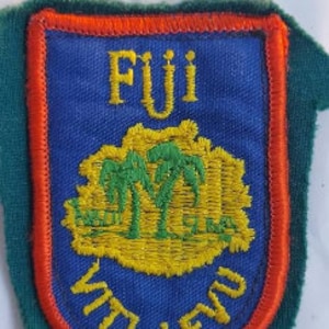 May include: A green, red, and blue embroidered patch with the words "Fiji Viti Levu" and a stylized image of palm trees.
