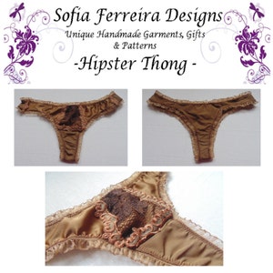 May include: A brown satin thong with a lace trim and a brown lace panel on the back. The thong is photographed from three different angles.