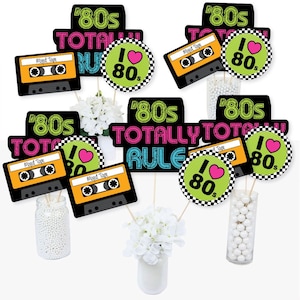 May include: A set of 80s themed party decorations. The decorations feature a cassette tape, a heart with the text "I love the 80s", and the text "80s Totally Rule".