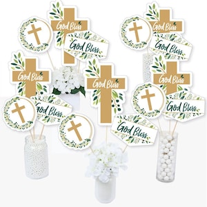 May include: A set of 10 green and gold cross and wreath centerpiece sticks with the text "God Bless" printed on each. The sticks are perfect for adding a religious touch to a party or event.