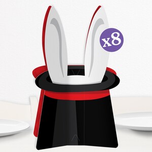 May include: A black and red magician's hat with white rabbit ears, a classic party decoration. The hat has a red lining and a black brim. A purple circle with the text "x8" is visible.
