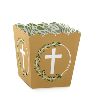 May include: A gold favor box with a white cross and green leaves design. The box has a scalloped edge and is perfect for holding small gifts or treats.