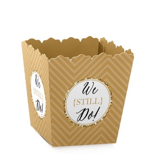 May include: Gold and white favor boxes with a chevron pattern and the text "We {STILL} Do!" in black script.
