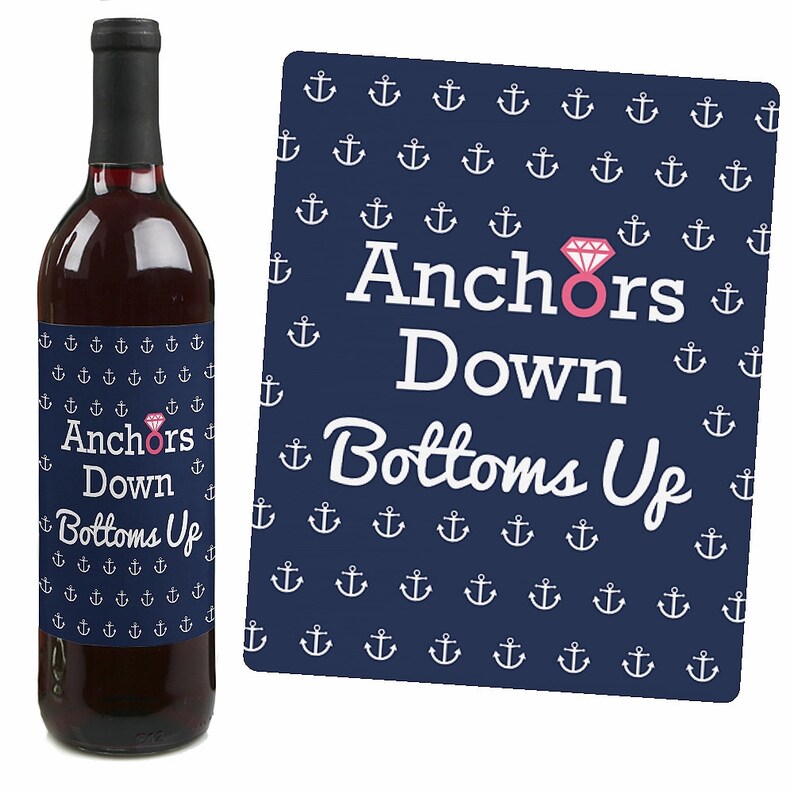 May include: A navy blue wine bottle label with white anchors and the text "Anchors Down Bottoms Up" with a pink diamond ring graphic.
