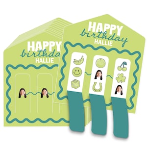 May include: A stack of light green birthday cards with the text "HAPPY birthday HALLIE" in white script. Each card has a teal border and a photo of a person. Three cards have illustrated icons: a banana, a smiley face, a dice, an orange, a horseshoe, cherries, and a four-leaf clover.