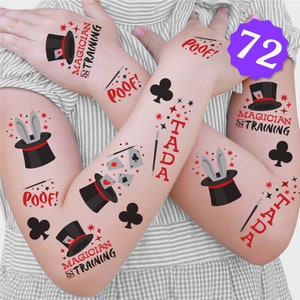 May include: A set of 72 temporary tattoos featuring a magician theme. The tattoos include images of top hats, rabbits, playing cards, stars, and the words "POOF!" and "TADA!"  The tattoos also include the phrase "Magician in Training".