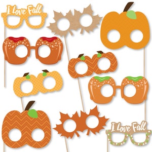 May include: Set of 10 fall-themed photo booth props featuring pumpkins, leaves, and glasses. The props have eye holes for photo fun. The props have a variety of patterns and colors, including orange, brown, green, and white.