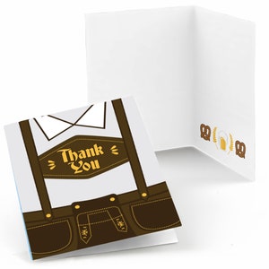 May include: A thank you card with a brown and white illustration of a man wearing lederhosen. The card says "Thank You" on the front. The back of the card has a brown pretzel, a beer stein, and wheat stalks.