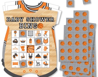 May include: Orange and gray baby shower bingo game with a basketball theme. The bingo card is shaped like a baby onesie and features images of baby items like a rattle, stuffed animal, and a rocking chair. The game includes 25 calling cards with images of basketballs.