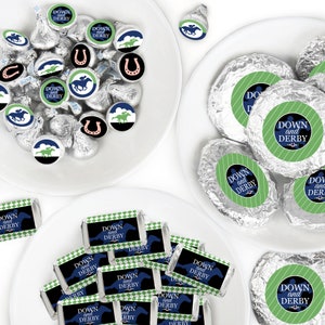 May include: Assortment of chocolate candies wrapped in silver foil with green and blue labels that say "Down and Derby". The labels feature a horse silhouette and a horseshoe. There are also smaller chocolate candies with horse and horseshoe designs.