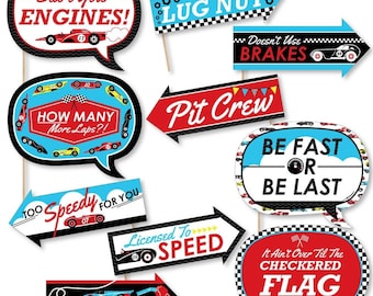 May include: Set of 10 red, blue, and black race car themed photo booth props. The props feature phrases like "Start Your Engines!" and "Too Speedy For You".
