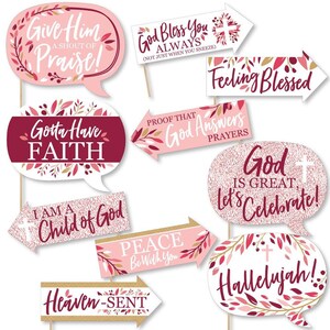 May include: A set of 10 pink and burgundy photo booth props with gold accents and floral designs. The props feature religious phrases like "Give Him Praise!" and "God Bless You Always".