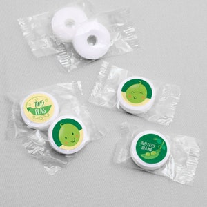May include: White round mints wrapped in clear plastic bags with green and white labels. The labels feature peas with faces and the text "Two Peas" and "Two Peas in a Pod".