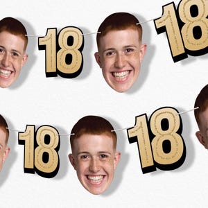 May include: A festive banner featuring the number "18" in gold glitter and smiling faces of a young person with red hair. The banner is strung on a white string, perfect for a birthday celebration.