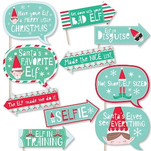 May include: Set of 10 Christmas elf photo booth props with festive sayings like "Have your Elf a Merry Little Christmas", "Get down with your Bad Elf", "Elf in Disguise", "Santa's Favorite Elf", "Made the Nice List", "The Elf made me do it", "Not Short. Elf Sized", "#Selfie", "Elf in Training", and "Santa's Elves see Everything".