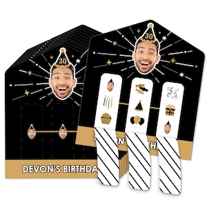 May include: A set of black and gold birthday party game cards with a person's face on each card. The cards have a black and white striped design and the text "DEVON'S BIRTHDAY".