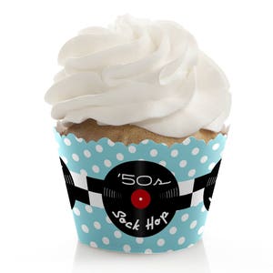 May include: Blue and white cupcake liner with white polka dots and a black and white record design. The record has the text '50s Sock Hop' and a red circle in the center.