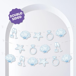 May include: A double-sided banner with light blue illustrations of champagne flutes, seashells, starfish, and diamond rings. The banner is strung on thin white cords, perfect for a wedding or bridal shower. The banner has a purple tag that says "DOUBLE SIDED".