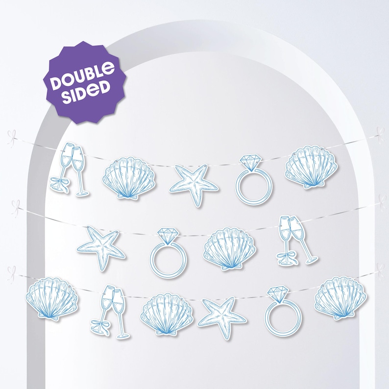 May include: A double-sided banner with light blue illustrations of champagne flutes, seashells, starfish, and diamond rings. The banner is strung on thin white cords, perfect for a wedding or bridal shower. The banner has a purple tag that says "DOUBLE SIDED".