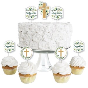 May include: Confirmation cake decorating kit with green and gold cross and leaf designs. The kit includes cupcake toppers and cake toppers with the word "Confirmation" on them.