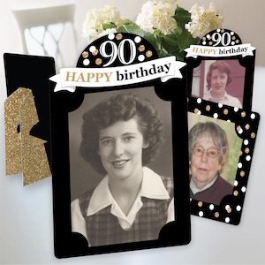 May include: Black and gold photo frame set with a banner that reads "90 Happy birthday". The frames have gold glitter accents and are perfect for displaying photos of a 90th birthday celebration.