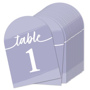 May include: A stack of 20 lavender table number cards with a white brushstroke design. The card reads "table 1" in white script font.