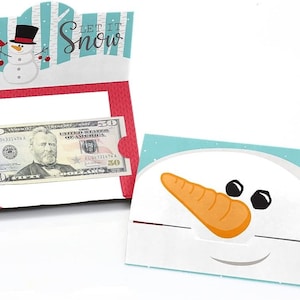 May include: A snowman-shaped card with a slot for cash. The card has a blue and white background with the text "Let It Snow".