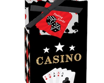 May include: Black and red casino themed favor boxes with gold glitter text that says "Casino". The boxes have a red and white diamond pattern and a tag that says "Feeling Lucky" with dice.