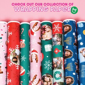 May include: A collection of eight different wrapping paper rolls. The rolls feature various designs, including snowflakes, candy canes, menorahs, and family photos. The text "CHECK OUT OUR COLLECTION OF WRAPPING PAPER" is at the top of the image.