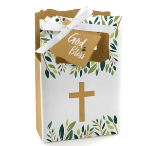 May include: White favor bags with a gold cross and green leaves. The bags have a tag that says "God Bless".