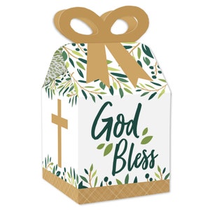 May include: Favor boxes with a white background and green leafy designs. The boxes have a gold bow and a gold cross on the side. The front of the box says "God Bless" in green lettering.