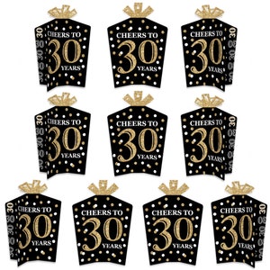 May include: Ten black and gold table decorations with white polka dots. Each decoration features a gold number "30" with the text "Cheers to 30 Years".