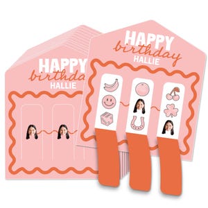 May include: Pink birthday cards with the text "HAPPY birthday HALLIE" in white script. The cards have a scalloped orange border and include stickers with fruit, smiley faces, and a photo of a person.
