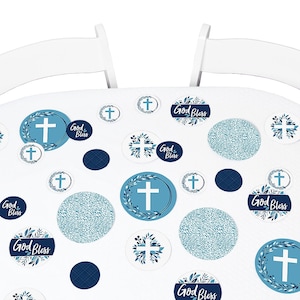 May include: Blue and white table confetti with crosses, wreaths, and the text "God Bless".